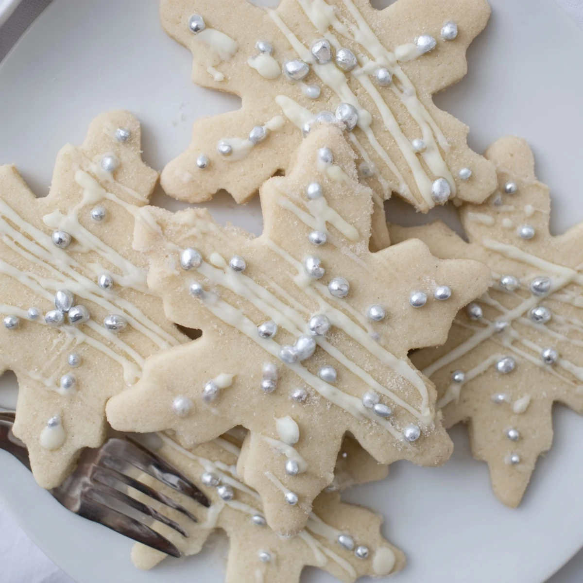 Golden-edged Winter Snowflake Platter cookies, drizzled white chocolate and shimmering sugar pearls.