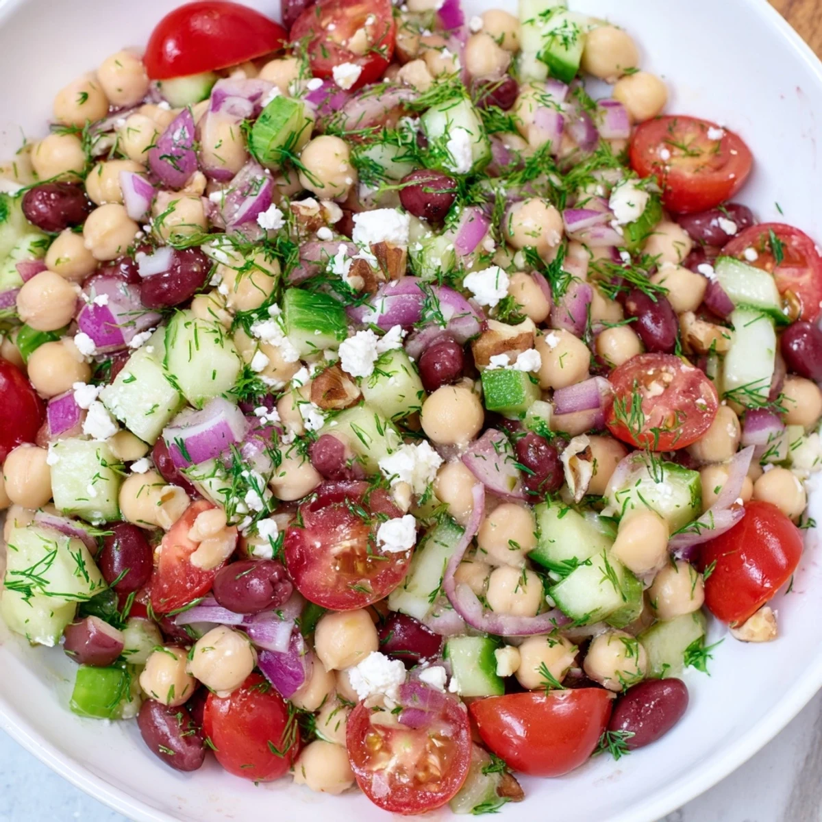 A vibrant bowlful of colorful Dense Bean Salad with Sleepy Girl Mocktail Dressing, inviting you to enjoy this healthy dish.