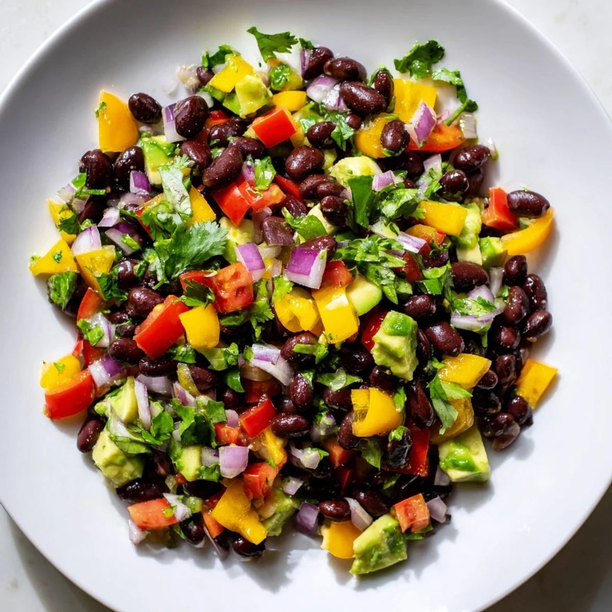 Delicious Southwest Black Bean Salad, ready to eat with a side of tortilla chips, perfect for a light lunch.