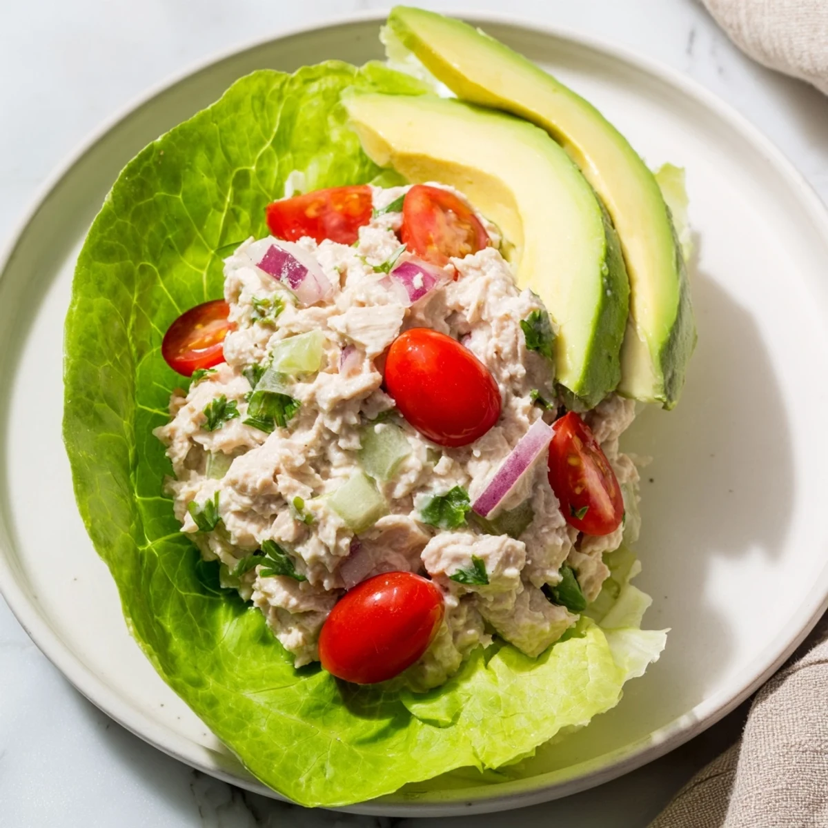 Creamy tuna salad lettuce wraps, filled in fresh lettuce, a healthy and delightful lunchtime choice.