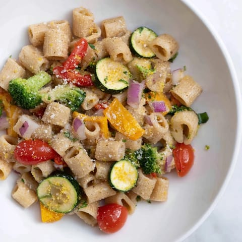 A close-up of colorful ditalini with air-fried vegetables, a healthy Italian-inspired meal.