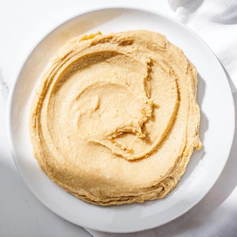 This photo features warm Emirati Al Madrooba, a smooth date paste perfect for spreading on bread.