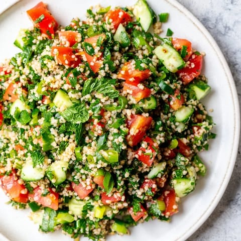Close-up of a refreshing Lebanese Tabbouleh Salad, with bright herbs and juicy tomatoes.