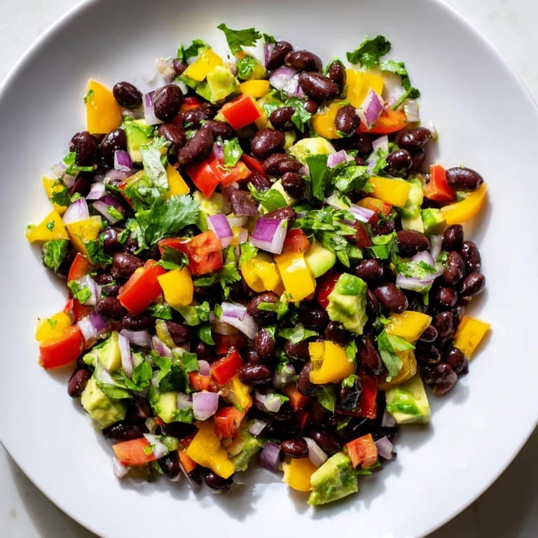 Delicious Southwest Black Bean Salad, ready to eat with a side of tortilla chips, perfect for a light lunch.