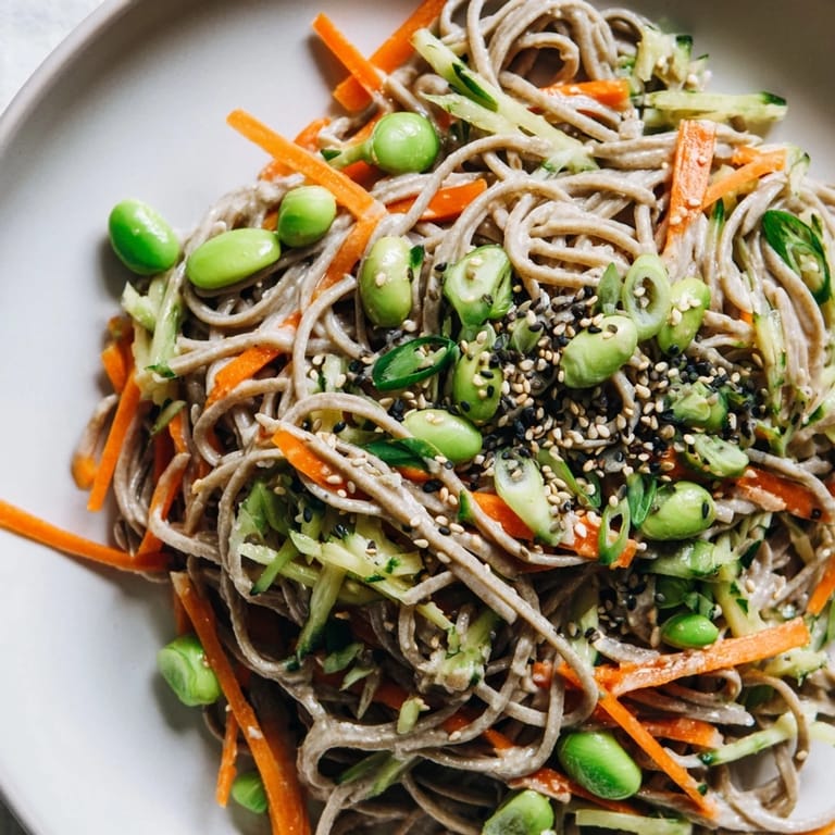 This Asian Sesame Noodle Salad, tossed beautifully, features sesame seeds sprinkled over fresh ingredients.